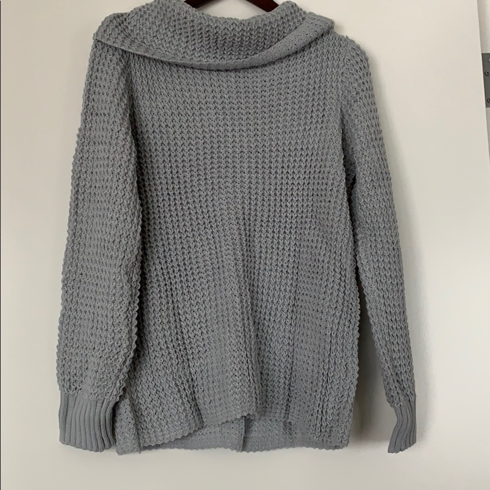 Grey knitted sweater.